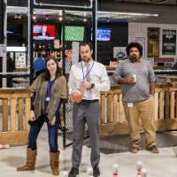 Two alumni pose for a fun photo at the Fowling Fun Event